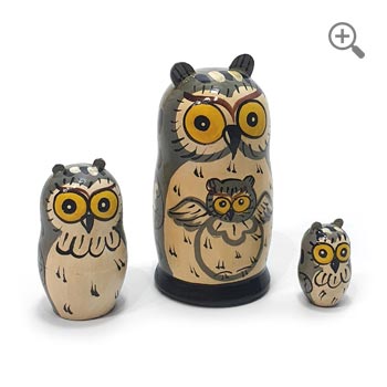 Hand-painted gray owl matryoshka dolls, three-piece Russian nesting doll set with golden-yellow eyes and detailed folk art designs, arranged by size on a clean white background
