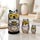 Hand-painted gray owl matryoshka set displayed on a light marble tabletop, featuring three Russian nesting dolls with expressive golden eyes in a softly blurred elegant home interior