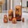 Horse nesting dolls arranged on a reflective marble surface, with five hand-painted wooden figures showcasing detailed equestrian portraits in a contemporary interior