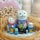 Colorful cat nesting dolls arranged in a rustic straw nest, featuring charming hen and chick artwork.