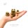 Tiny owl nesting dolls displayed on an open hand, showing five miniature Russian Matryoshka pieces in different sizes, with detailed hand-painted owl designs.